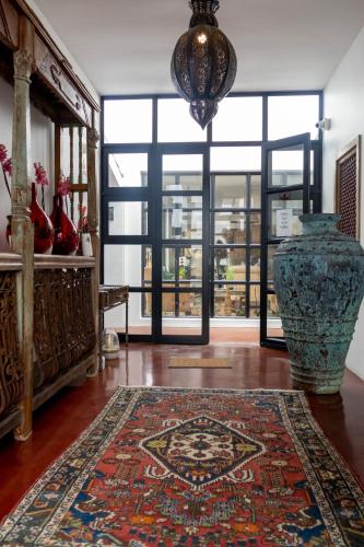 a room with a vase and a rug on the floor at The Rez Guesthouse in Walvis Bay