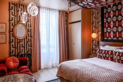 a hotel room with a bed and a window at Maison La Bohème Montmartre - Studios & Apartments in Paris