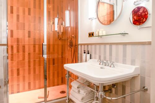 a bathroom with a sink and a shower at Maison La Bohème Montmartre - Studios & Apartments in Paris