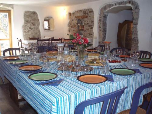 a table with plates and glasses on top of it at Il Borgo della Colomba in Fosdinovo