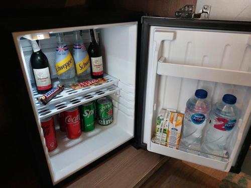 an open refrigerator filled with drinks and drinks at Italia Hotel cairo in Cairo
