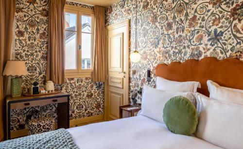 a hotel room with a bed and a window at Maison La Bohème Montmartre - Studios & Apartments in Paris