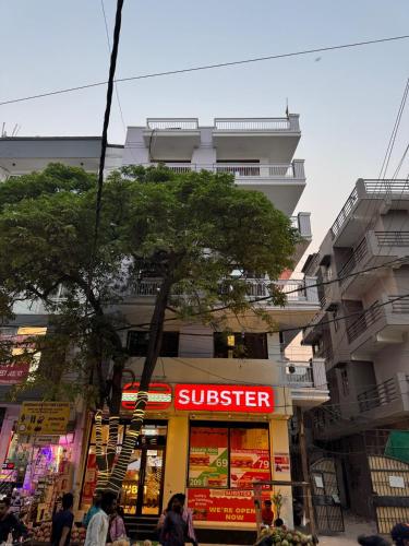 a store with a superstar sign in front of a building at Greece vibes Spacious flat, private, cozy space in Delhi and NCR in New Delhi