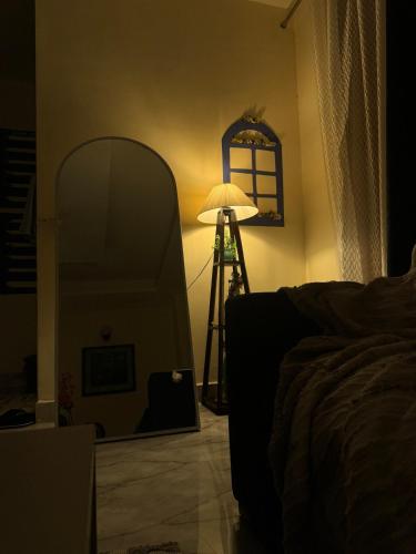 a room with a lamp and a mirror and a lampost at Greece vibes Spacious flat, private, cozy space in Delhi and NCR in New Delhi