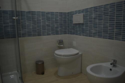a bathroom with a toilet and a sink at Grottammare Summer Apartment in Grottammare