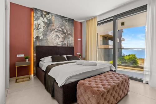 a bedroom with a large bed and a large window at Luxury Seaside Apartments Zadar in Zadar
