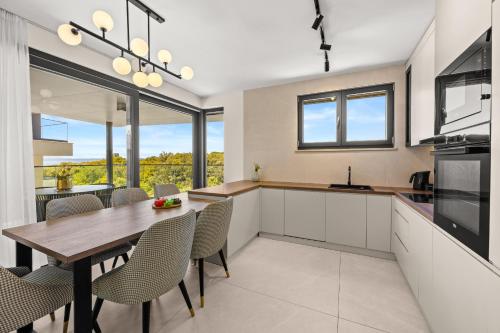 a kitchen and dining room with a table and chairs at Luxury Seaside Apartments Zadar in Zadar