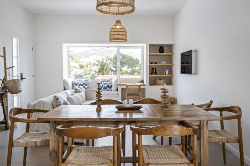 a dining room with a wooden table and chairs at Casa do Cacto - By WeHost in Porto Santo