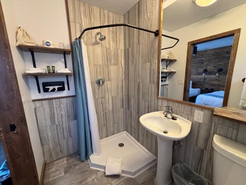 a bathroom with a shower and a sink at Aqua Aire Inn & Suites in Minocqua