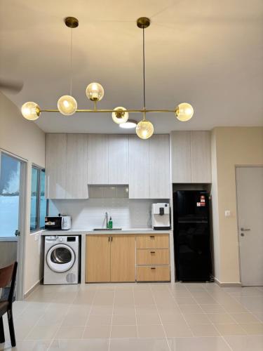 a kitchen with a black refrigerator and a dishwasher at Ruhani Guesthouse KL Setapak Muji Style in Kuala Lumpur