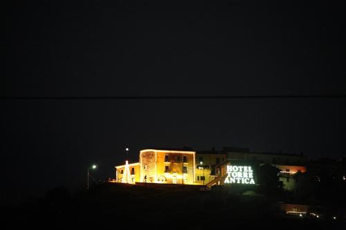 a lit up building at night in the dark at Hotel Villa Torre Antica in Atena Lucana
