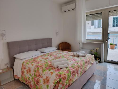 a bedroom with a bed with two towels on it at La Tartana in Castro di Lecce
