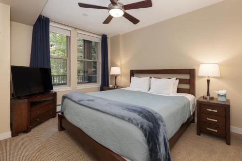 a bedroom with a bed and a flat screen tv at Fraser Crossing 3227 Ski In Ski Out Winter Park Resort in Winter Park