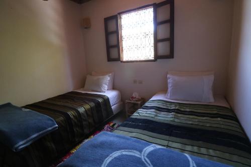 Ein Bett oder Betten in einem Zimmer der Unterkunft Gîte Imsker Elbour