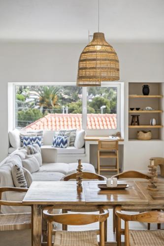 a living room with a couch and a table at Casa do Cacto - By WeHost in Porto Santo