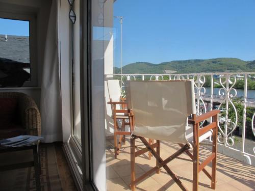 a pair of chairs sitting on a balcony at Mosel - River - Quartier 31 in Lieser