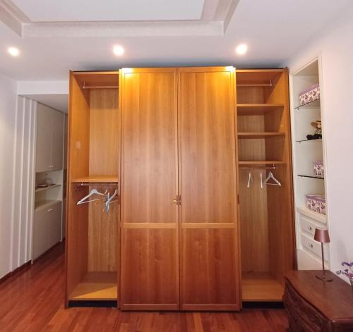 a closet with wooden cabinets in a room at A casa di Lilly in Rome