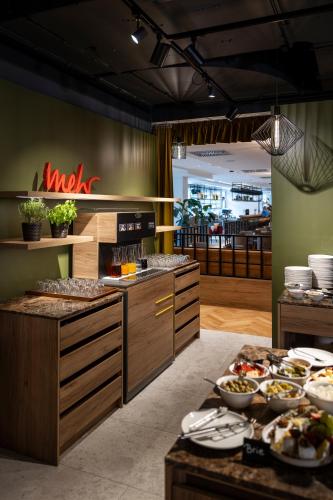 a kitchen with many plates of food on a table at ARCOTEL AQ Wien in Vienna