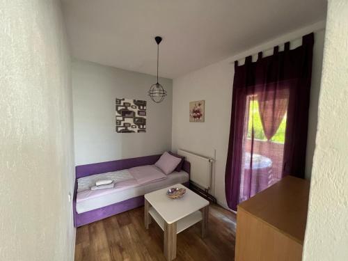 a small living room with a couch and a table at House Dea in Mostar