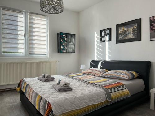 a bedroom with a bed with towels on it at House Dea in Mostar