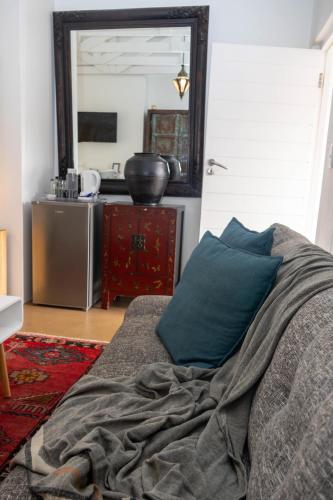 a bedroom with a bed with a mirror and a table at The Rez Guesthouse in Walvis Bay