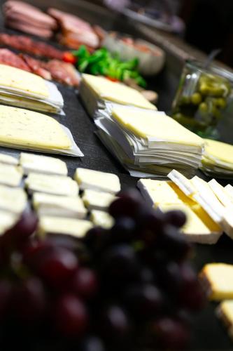 a bunch of cheese and grapes on a table at Hotel Deutschherrenhof in Zeltingen-Rachtig