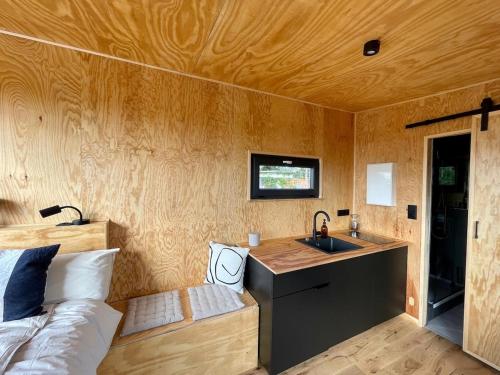 a small room with a sink and a bed at tiny ausblick mit sauna in Groß Garz