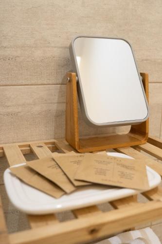 a white phone sitting on top of a wooden table at Catania Over Time - Tourist Rooms in Catania