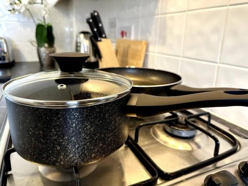 two pots sitting on top of a stove at Riverside View by Blue Skies Stays in Middlesbrough