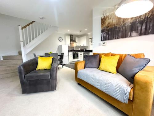 a living room with a couch and a chair at Bourneville House by Blue Skies Stays in Stockton-on-Tees