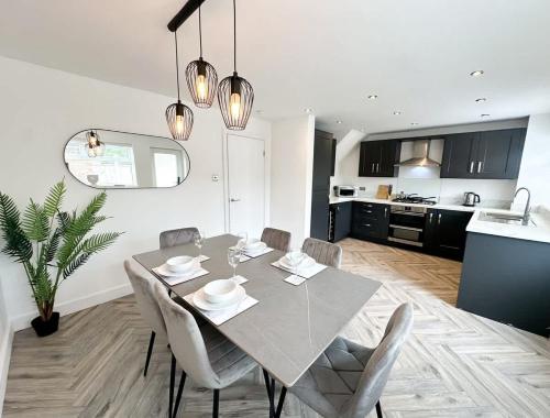 a dining room and kitchen with a table and chairs at Marham House by Blue Skies Stays in Middlesbrough