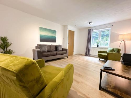 a living room with a couch and a table at Anchorage Place by Blue Skies Stays in Thornaby on Tees