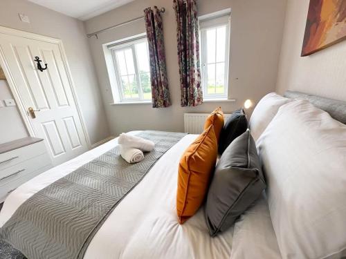 a bed with two pillows on it in a bedroom at Geranium House by Blue Skies Stays in Stockton-on-Tees