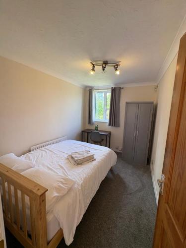 a bedroom with a large white bed with a window at 3-bed house with parking in CB1 in CBG