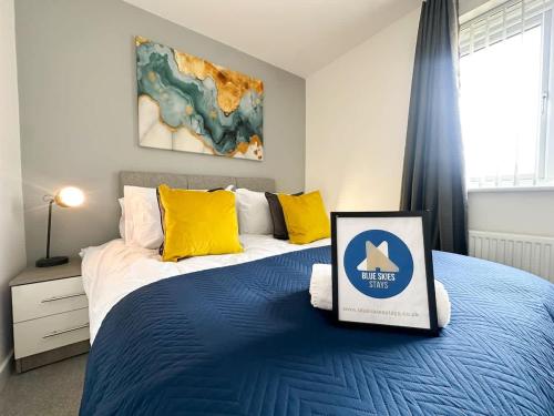 a bedroom with a blue bed with a sign on it at Deepdale House by Blue Skies Stays in Stockton-on-Tees