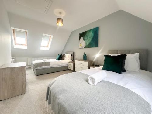 a large bedroom with two beds and a couch at Deepdale House by Blue Skies Stays in Stockton-on-Tees