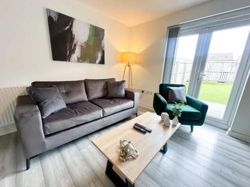 a living room with a couch and a coffee table at Deepdale House by Blue Skies Stays in Stockton-on-Tees