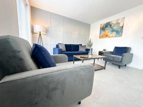a living room with a couch and chairs and a table at Fullerton House by Blue Skies Stays in Thornaby on Tees