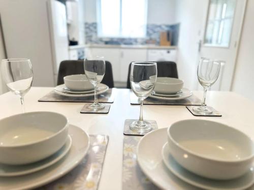 a table with plates and wine glasses on it at Fullerton House by Blue Skies Stays in Thornaby on Tees