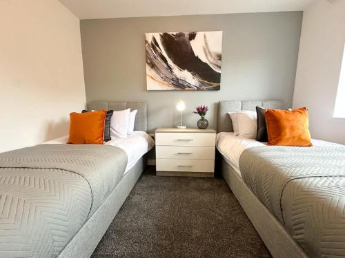 two beds sitting next to each other in a bedroom at Essex House by Blue Skies Stays in Stockton-on-Tees