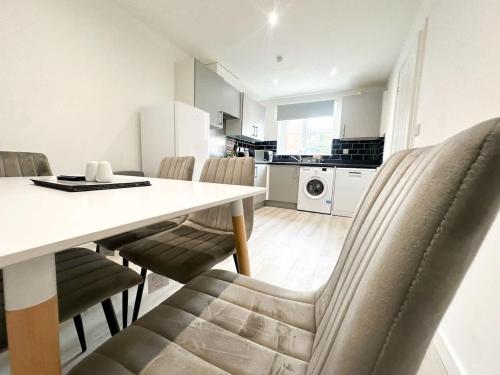 a kitchen and dining room with a table and chairs at Essex House by Blue Skies Stays in Stockton-on-Tees