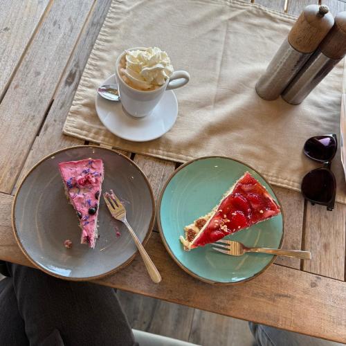 a table with two plates of pizza and a cup of coffee at EMSLAND-CAMP in Haar