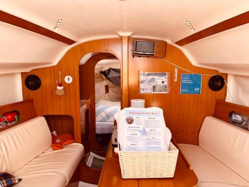 a small room with a table and a bed at Surfbird Cozy Sailboat Escape in Lisbon