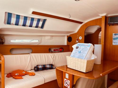 a living room with a couch and a table at Surfbird Cozy Sailboat Escape in Lisbon