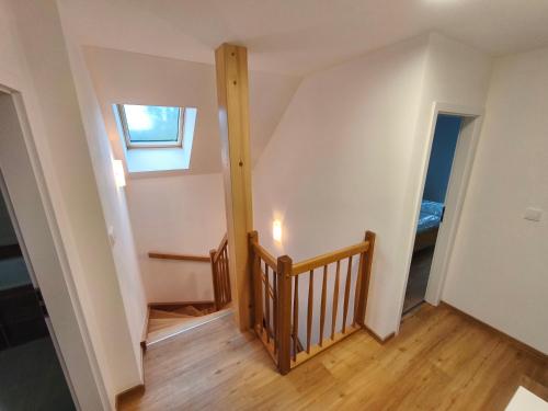 a room with a staircase and a window at Prázdninová Vila Žďár in Žďár