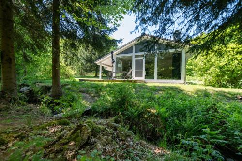 a small cottage in the woods with trees at 4 Personen mit Sauna F0H3 in Ruhla