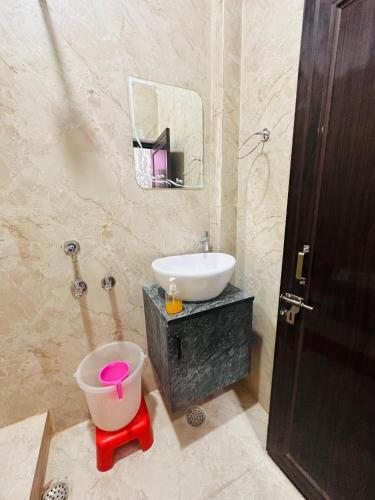 a bathroom with a sink and a toilet and a sink at Hotel Airport Suites Suitable for Hourly Bookings in Lucknow