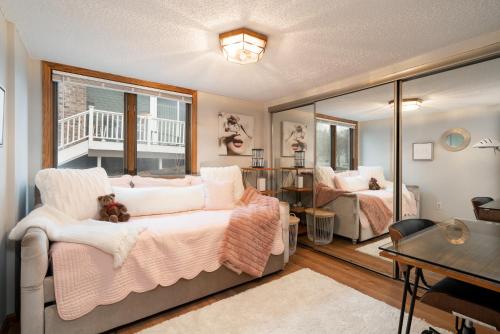 a bedroom with a bed and a table and a mirror at Creekside Lodge in Minnetonka