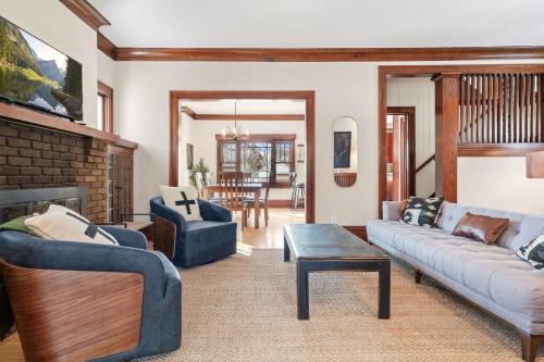 a living room with two couches and a fireplace at Fulton Lodge in Edina