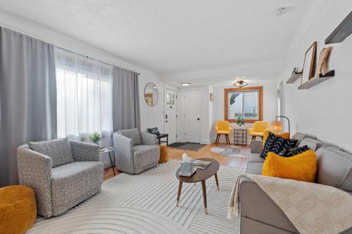 a living room with a couch and chairs and a table at Richfield Gem in Richfield